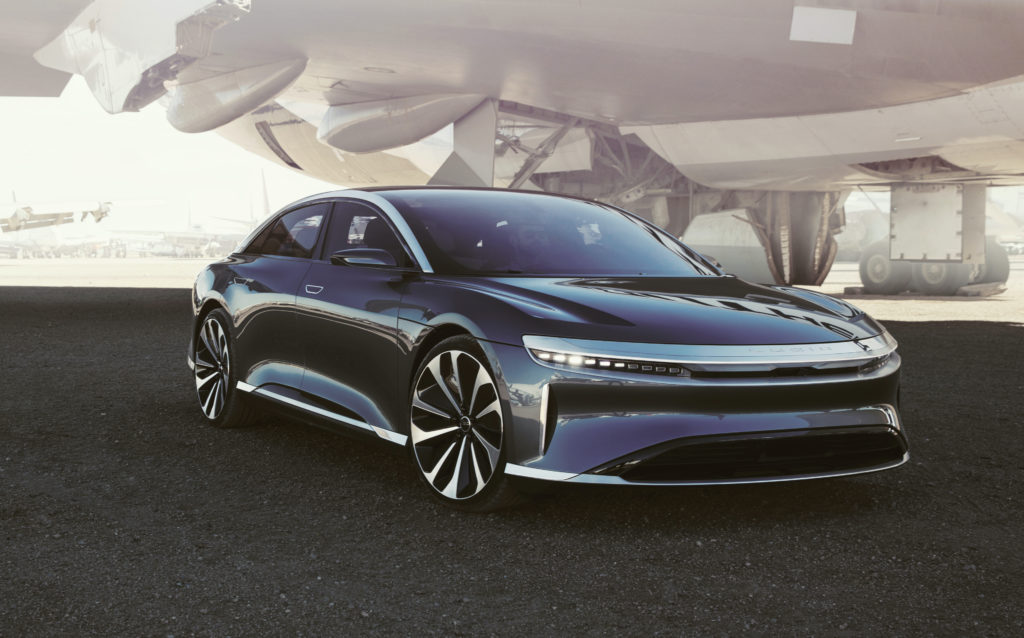 רכב חשמלי בצבע שחור של חברת לוסיד - Lucid Air עם כנף של מטוס מאחור